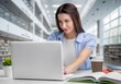 © BillionPhotos.com - Student typing on laptop, studying in library