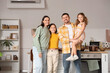 © Pixel-Shot - Portrait of parents with their daughters in kitchen
