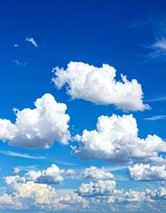 Wall Mural - Bright blue sky with fluffy white cumulus clouds on a summer day