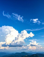 Wall Mural - Bright blue sky with fluffy white cumulus clouds on a summer day