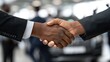 © Mey - Two men shaking hands in a car showroom.
