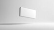 © KE - A white rectangular prism floats horizontally with sharp edges,