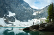 © Viks - Lone figure admires vast mountain and glacial lake scenery