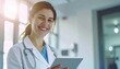 © Hyejin Kang - Female doctor, portrait and smile with tablet in hospital or workplace with lens flare.