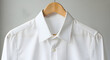 © Mouatessembillah - Close-up of White Pleated Tuxedo Shirt on Wooden Hanger