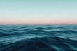 © Nasra - Ocean waves under a clear gradient sunset sky