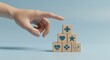 © Pixelia - Hand Pointing Towards Wooden Cubes with Healthcare Symbols