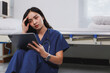 © crizzystudio - Stressed young doctor reading bad news on tablet in hospital room