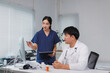 © crizzystudio - Medical professionals discussing patient data on computer in hospital room