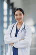 © crizzystudio - Portrait of smiling asian female doctor wearing white coat and stethoscope