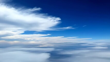 Wall Mural - Fast-moving white clouds race across a deep blue sky, creating dynamic shadows in a time-lapse contrast, fast-moving white clouds, dynamic