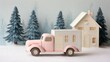 © MKS - In a soft pastel winter wonderland, a charming pink holiday delivery van with a big festive bow drives past miniature snow-dusted trees, sparkling ornaments, and a cozy pink house, creating a magical