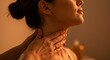 © Lebay - Gentle hand touches womans neck in soft light for relaxation and wellness