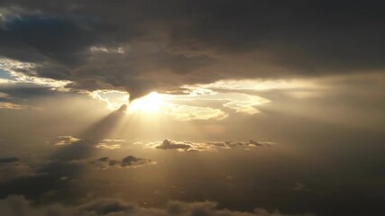 Wall Mural - Dramatic sunbeams pierce through heavy cloud cover, creating a majestic light display in the sky light, atmospheric, golden