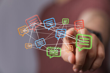 A person interacting with a network of digital message bubbles, representing communication and connection. This image is perfect for technology,