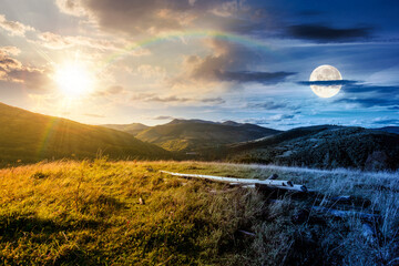 Wall Mural - countryside mountain landscape on autumn equinox. day and night time change concept. rural field on hills. beautiful scenery with grassy meadows and forested slopes in highland with sun and moon