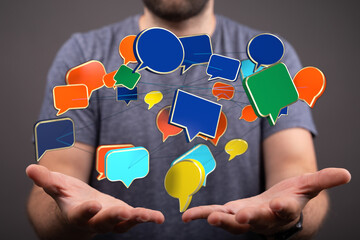 Man presenting 3D render of speech bubbles. It represents social media and communication in the digital age.