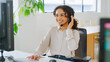 © Monkey Business - Woman Wearing Headset Sitting At Desk Working In Office Call Centre Team Taking Call