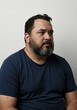 © Laura - Overweight man with facial hair and acne scars, thoughtful pose, white background