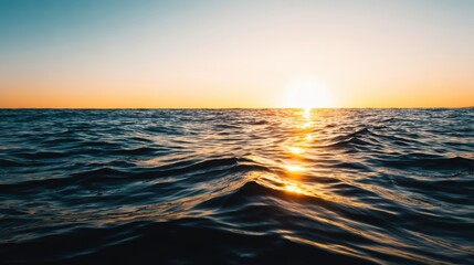 Wall Mural - Serene sunset over tranquil ocean waves, reflecting golden light, evoking calm and beauty at dusk