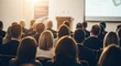 © Alice C - Professional audience in formal attire seated in modern conference room during business presentation. Attendees focus on speaker at front. Ideal for corporate training and business education.