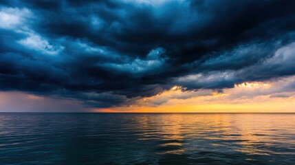 Wall Mural - Dramatic sunset over calm ocean waters with dark storm clouds gathering on the horizon