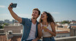 © Lacobus - Cheerful young couple making memories with a rooftop selfie and refreshing drinks enjoying city views on a beautiful day perfect for summer fun