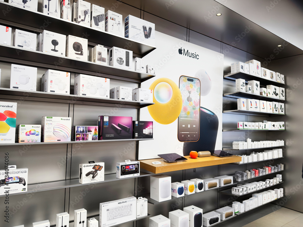 In store Apple Music display with shelves of electronics, gadgets, and ...