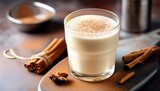 glass of vanilla protein shake with cinnamon sprink