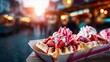 © evgenia_lo - Deliciously Indulgent Waffles Topped with Fresh Strawberries, Cream, and Sweet Syrup at a Festive Marketplace During Golden Hour