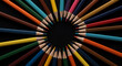 © Amanda - A high-angle shot of many colorful, sharpened pencils arranged in a perfect radial circle with tips pointed inward towards a black center. Abstract studio photo.