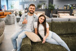 © Serhii - Happy couple shopping for new sofa in furniture store