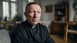 © liliyabatyrova - Portrait of a middle aged Christian Priest sitting in an apartment, looking thoughtful or serious