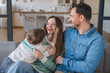 © InsideCreativeHouse - Caucasian parents family of three having fun with their little son at home, young mom and dad tickling male kid child and laughing together in living room, enjoying domestic leisure, copy space