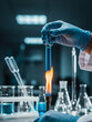 © nixartmd - Gloved hands of a scientist heating a test tube with a blue chemical solution over a Bunsen burner