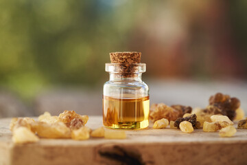 Wall Mural - A bottle of frankincense essential oil with frankincense resin