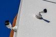 © SMK - Two security cameras mounted on a building corner monitor the area, capturing footage against a bright blue sky