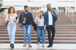 © Serhii - University students walking down campus stairs together