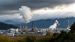 © A2Z AI  - Industrial Complex Under Cloudy Sky: A sprawling industrial complex rises against a backdrop of moody, cloudy skies and distant mountains.