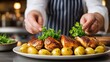 © Lubos Chlubny - Chef garnishing roasted chicken with potatoes and parsley in restaurant kitchen