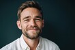 © Alina - Smiling man against blue background