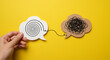 © Arfan - A hand holds a speech bubble representing clear, organized thought connecting to a tangled, messy one, symbolizing problem-solving and finding clarity from confusion on a vibrant yellow background