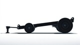 Low-angle shot of a black trailer frame with wheels isolated against a white backdrop