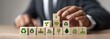 © Karta - Wooden blocks with environmental icons are arranged in a stack, demonstrating sustainable development. A person in a business suit is placing a block on top of the stack