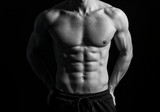 Muscular Body: A grayscale image of a sculpted male torso showcasing a defined six-pack and strong physique, representing fitness, health, and body-building ideals.