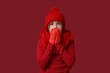 © Pixel-Shot - Frozen cute little boy in winter clothes on red background
