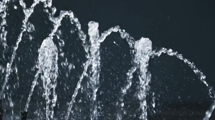 Wall Mural - A slow dolly shot reveals a spectacular slow motion water fountain, with countless droplets sparkling under studio illumination pure, commercial, experiment