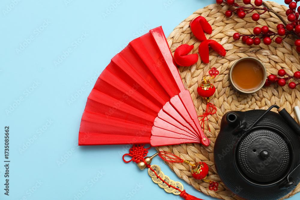Teapot with cup and Chinese symbols on blue background. New Year celebration