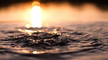 Wall Mural - golden hour sunlight creates stunning glints on a frothy slow motion water splash, highlighting text