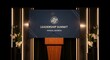 © Suwantono - Leadership Summit Presentation Podium and Screen Announce Annual Address with Floral Decor